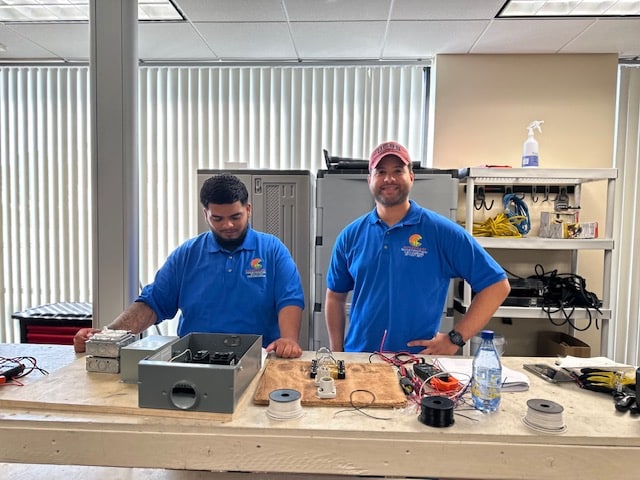 Trade school students in hands-on training session